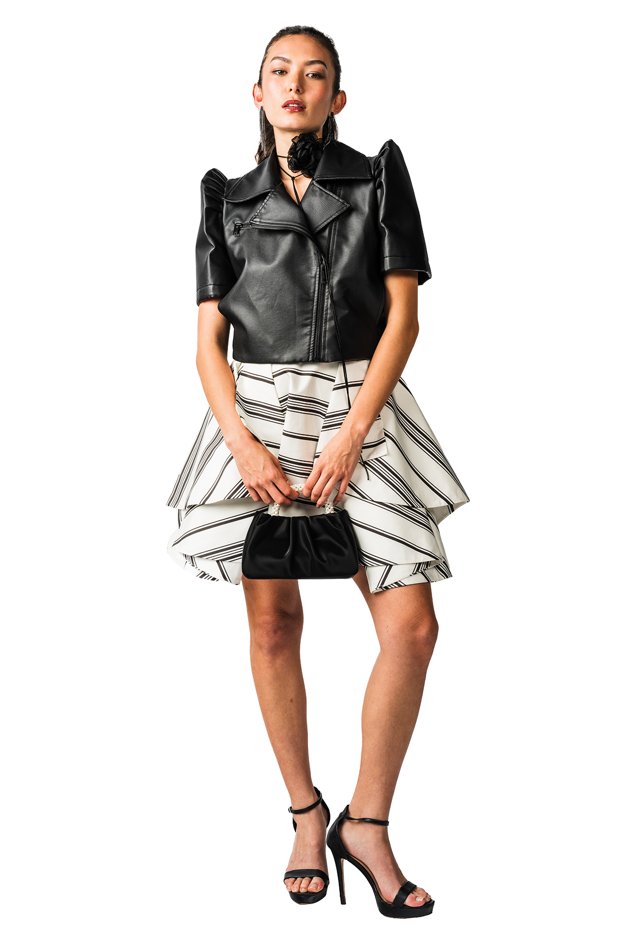 Woman wearing a black leather top and striped skirt on a white background