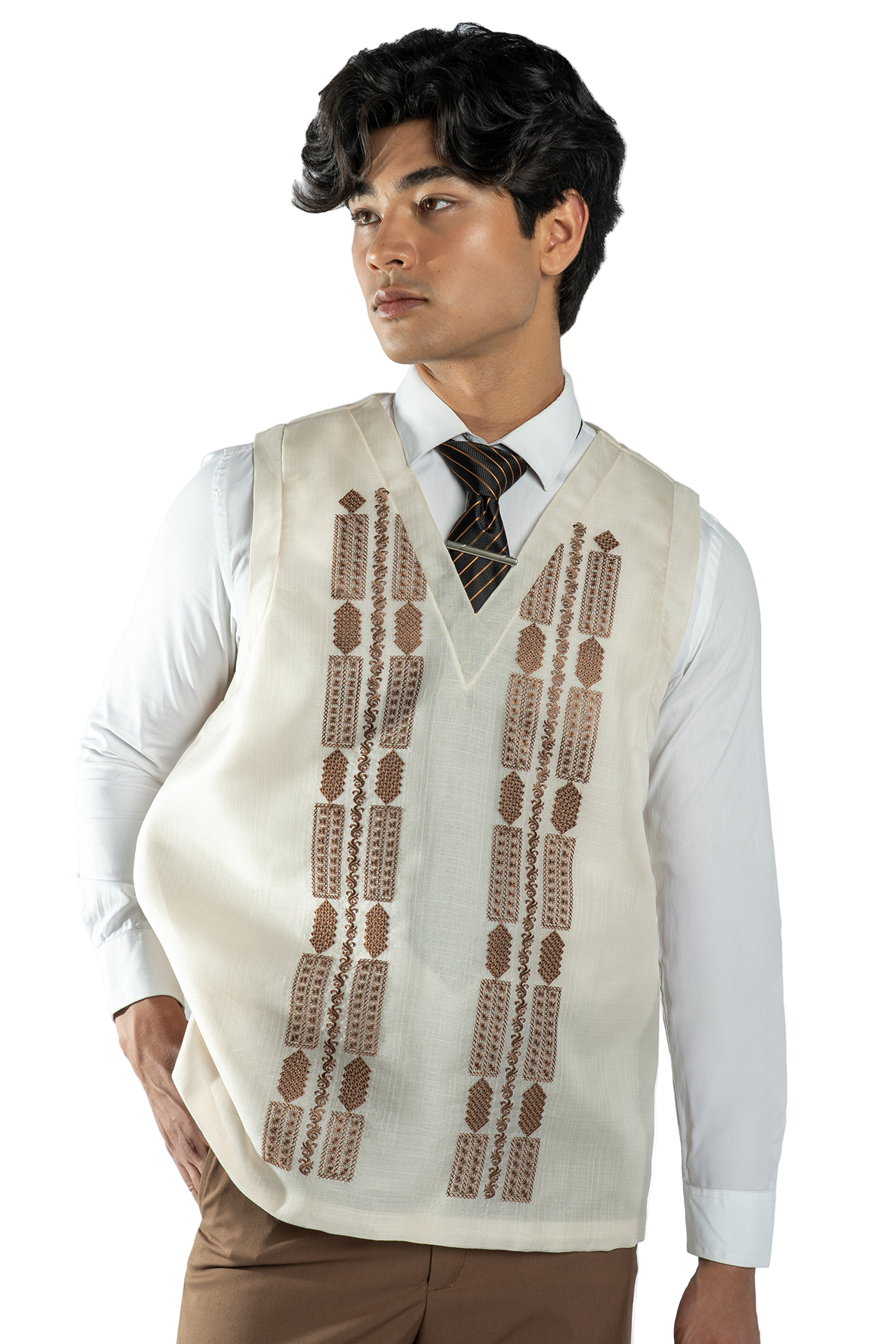 Man wearing a cream-colored vest with brown patterns over a white shirt on a white background