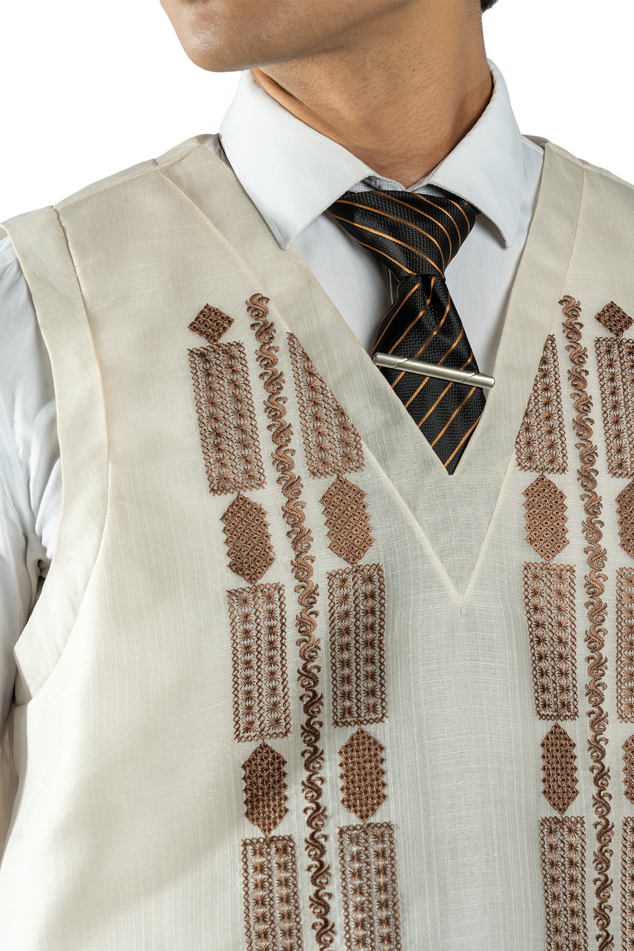 Beige embroidered vest over a white shirt with a patterned tie on a white background