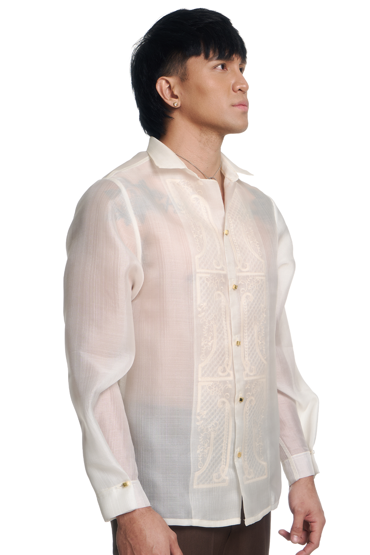 A man wearing a white barong shirt with intricate embroidery on the front panel, shown in a side profile against a white background.