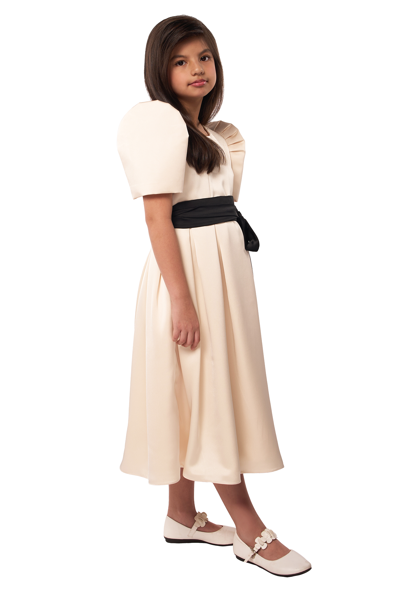 Young girl wearing a white dress with a black belt on a white background