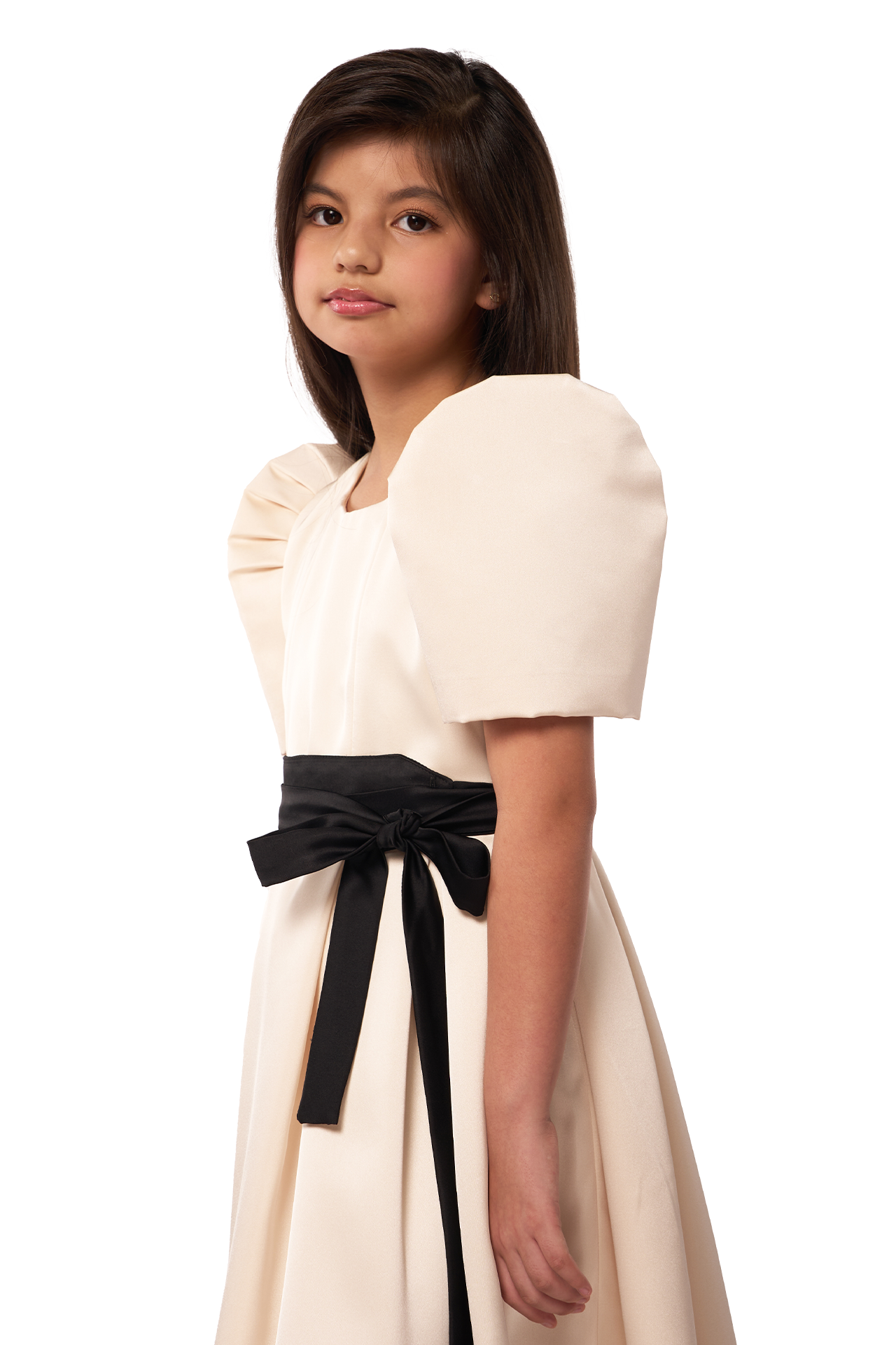 Young girl wearing a white dress with a black belt on a white background